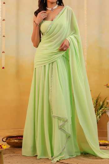 B'Infinite Green Pastel Ruffle Embellished Draped Saree With Blouse For Kids at Aza Fashions B'Infinite_Green Pastel Ruffle Embellished Draped Saree With Blouse For Kids_at_Aza_Fashions