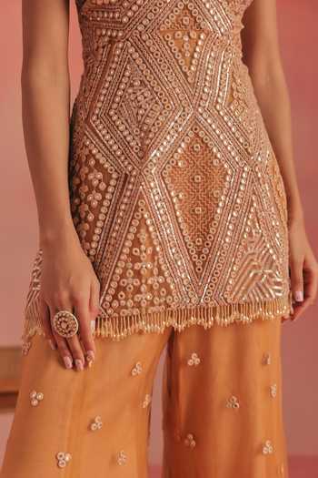 Twenty Nine Orange Net Plunge Neck Embroidered Backless Peplum Tunic at Aza Fashions Twenty Nine_Orange Net Plunge Neck Embroidered Backless Peplum Tunic _at_Aza_Fashions
