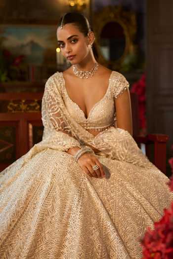 Seema Gujral_Ivory Net Sweetheart Neck Crystal Embroidered Lehenga Set _Online_at_Aza_Fashions