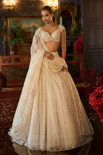 Seema Gujral_Ivory Net Sweetheart Neck Crystal Embroidered Lehenga Set _at_Aza_Fashions