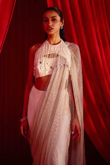 NIDHIKA SHEKHAR Ivory Crepe Halter Neck Jhilmil Anvaya Pre-draped Saree With Blouse at Aza Fashions NIDHIKA SHEKHAR_Ivory Crepe Halter Neck Jhilmil Anvaya Pre-draped Saree With Blouse _at_Aza_Fashions