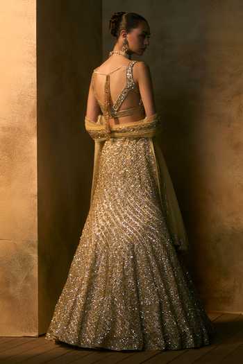 Shop Angad Singh Gold Net Scoop Neck Soleil Tonal Sequin Embroidered Fishcut Lehenga Set at Aza Fashions Shop_Angad Singh_Gold Net Scoop Neck Soleil Tonal Sequin Embroidered Fishcut Lehenga Set _at_Aza_Fashions