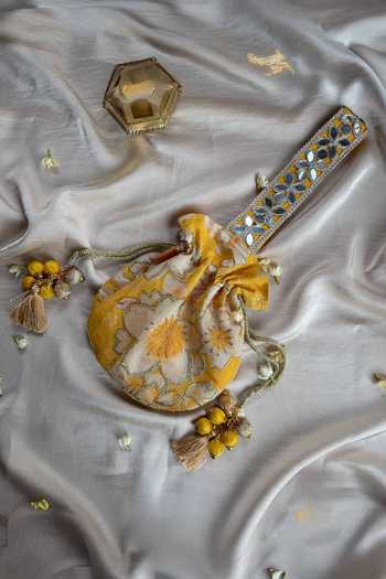 Quirky Tales Yellow Embroidery, Mirrors, Tassels Floral Work Strap Potli at Aza Fashions Quirky Tales_Yellow Embroidery, Mirrors, Tassels Floral Work Strap Potli _at_Aza_Fashions