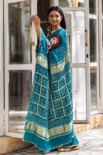 Shop Geroo Jaipur Blue Silk, Modal Round Neck Bandhani And Zari Gharchola Pallu Saree With Blouse Online at Aza Fashions Shop_Geroo Jaipur_Blue Silk, Modal Round Neck Bandhani And Zari Gharchola Pallu Saree With Blouse _Online_at_Aza_Fashions