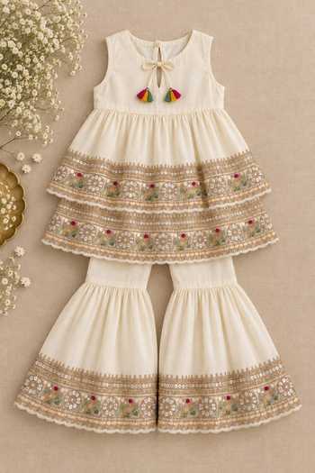 Shop MI Dulce An'Ya Ivory Cotton, Chanderi Embroidered Top And Layered Sharara Set Online at Aza Fashions Shop_MI Dulce An'Ya_Ivory Cotton, Chanderi Embroidered Top And Layered Sharara Set _Online_at_Aza_Fashions