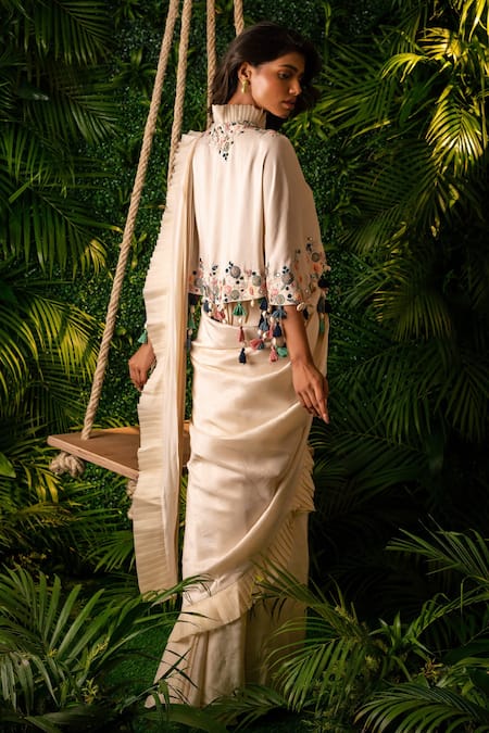 Shop Pallavi Poddar Ivory Organza, Denim Tassels Daffodil Pre-draped Saree With Embroidered Cape at Aza Fashions Shop_Pallavi Poddar_Ivory Organza, Denim Tassels Daffodil Pre-draped Saree With Embroidered Cape _at_Aza_Fashions