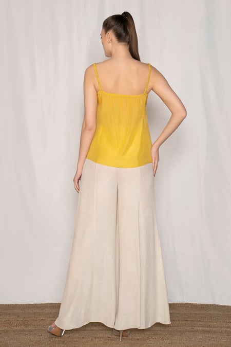 Shop Amrta By Guneet Kondal Yellow Viscose Pearls, Beads, Zari Scoop Neck Embroidered Top And Flared Pant Set at Aza Fashions Shop_Amrta By Guneet Kondal_Yellow Viscose Pearls, Beads, Zari Scoop Neck Embroidered Top And Flared Pant Set _at_Aza_Fashions
