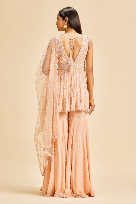Shop Nitika Gujral Peach Peplum Top And Sharara Georgette & Dupatta Net Embroidery Sequin Set at Aza Fashions Shop_Nitika Gujral_Peach Peplum Top And Sharara Georgette & Dupatta Net Embroidery Sequin Set _at_Aza_Fashions
