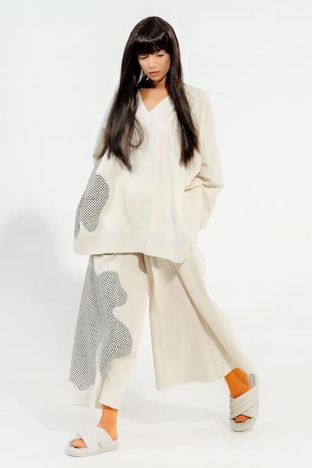 Shop Stoique Off White Cotton Muslin Applique Avocado Work Flared Pant at Aza Fashions Shop_Stoique_Off White Cotton Muslin Applique Avocado Work Flared Pant _at_Aza_Fashions