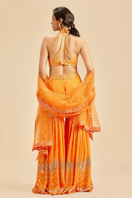 Shop Nitika Gujral Orange Blouse And Gharara Georgette Embroidery Sequin Halter Neck Set at Aza Fashions Shop_Nitika Gujral_Orange Blouse And Gharara Georgette Embroidery Sequin Halter Neck Set _at_Aza_Fashions