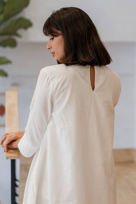 Shop Vanaras Off White Cotton Round Neck Perla Pintucked Bodice Dress at Aza Fashions Shop_Vanaras_Off White Cotton Round Neck Perla Pintucked Bodice Dress_at_Aza_Fashions