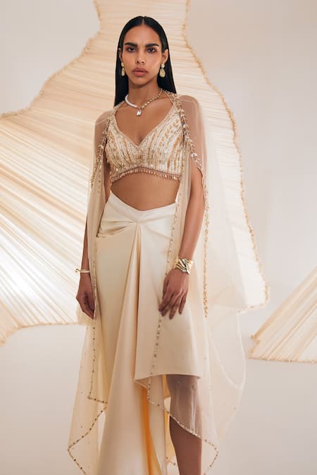 Shop Divya Aggarwal Ivory Satin Crystals, Pearls, Sequins V-neck Leaf Embroidered Cape Skirt Set Online at Aza Fashions Shop_Divya Aggarwal_Ivory Satin Crystals, Pearls, Sequins V-neck Leaf Embroidered Cape Skirt Set _Online_at_Aza_Fashions