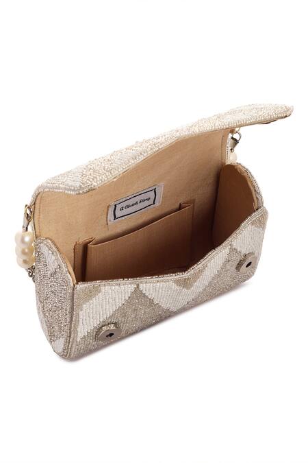 Shop_A Clutch Story_Silver Embroidery, Pearls Suede Metallic Zig Zag Flapover Clutch_Online_at_Aza_Fashions