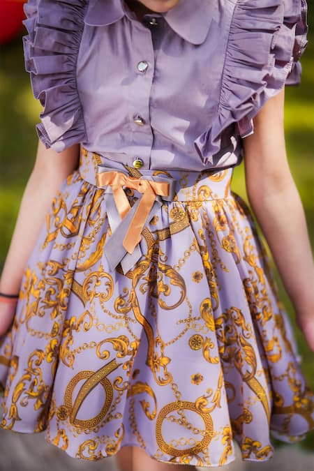 The Pony & Peony Co. Purple Cotton Embroidery, Bows Flutter Sleeve Top And Printed Skirt at Aza Fashions The Pony & Peony Co._Purple Cotton Embroidery, Bows Flutter Sleeve Top And Printed Skirt _at_Aza_Fashions