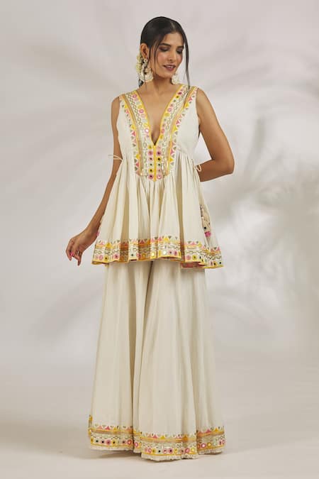 Shop Gopi Vaid Ivory Cotton Sequins, Mirrors Plunge Hana Embroidered Peplum Kurta With Sharara Online at Aza Fashions Shop_Gopi Vaid_Ivory Cotton Sequins, Mirrors Plunge Hana Embroidered Peplum Kurta With Sharara _Online_at_Aza_Fashions