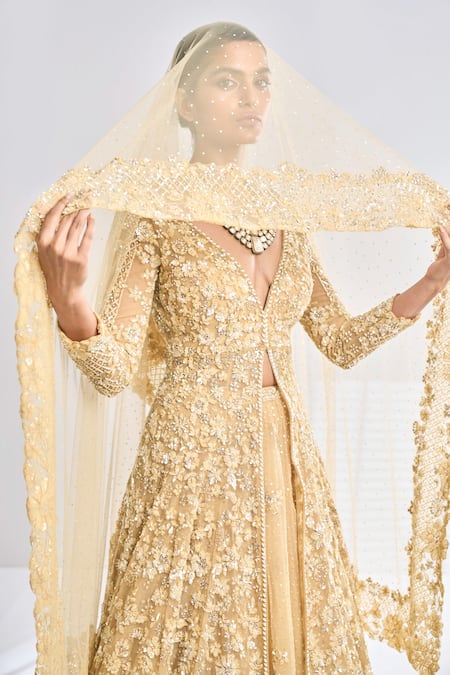 Seema Gujral_Gold Net Floral Plunge V Neck Embroidered Jacket Lehenga Set _at_Aza_Fashions