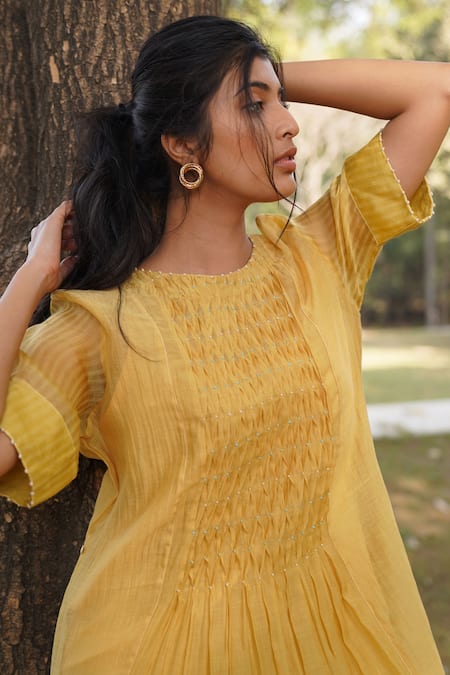 Shop_Dhaari_Yellow Handloom Cotton, Silk Tassels, Lace Round Neck Hand Smocked Dress _Online_at_Aza_Fashions