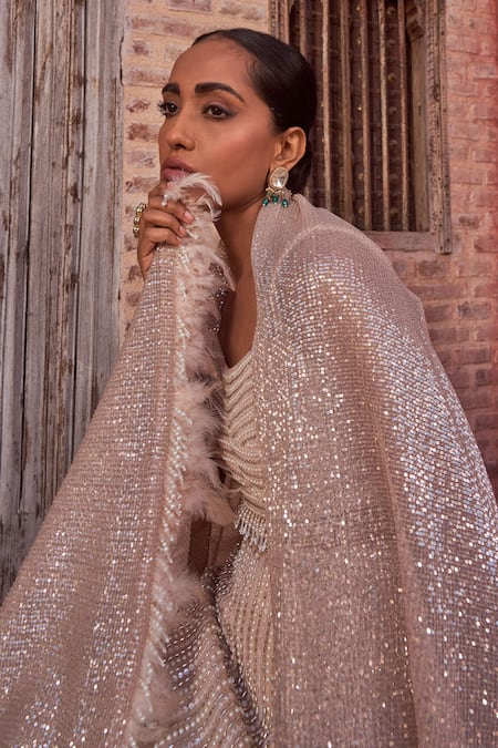 Nidhika Shekhar_Beige Silk, Georgette Sequins, Feathers, Beads, Embroidered Cape Lehenga Set _at_Aza_Fashions