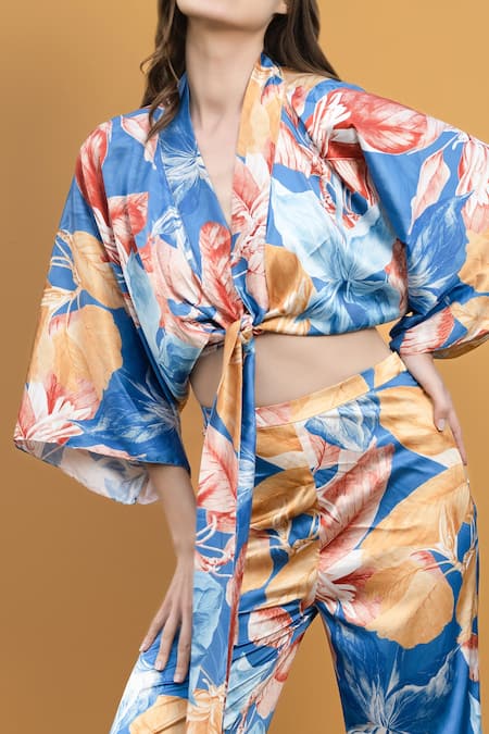 Mandira Wirk Resort_Blue Satin Hawaii Print V Neck Wrap Top And Bell Bottom Set_at_Aza_Fashions