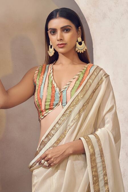Shop Affroz Ivory Tissue Silk Gota Patti Plunge V Sunehri Lace Border Saree With Blouse Online at Aza Fashions Shop_Affroz_Ivory Tissue Silk Gota Patti Plunge V Sunehri Lace Border Saree With Blouse _Online_at_Aza_Fashions