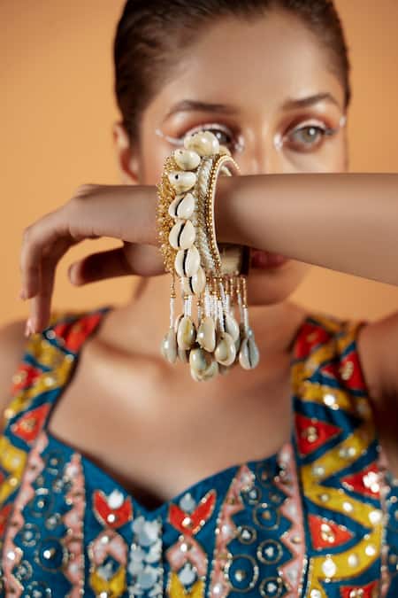 Kanyaadhan By Dhirajaayushi Gold Plated Beads Shell Tassel Bangles Set Of 2 Online at Aza Fashions Kanyaadhan By Dhirajaayushi_Gold Plated Beads Shell Tassel Bangles Set Of 2 _Online_at_Aza_Fashions