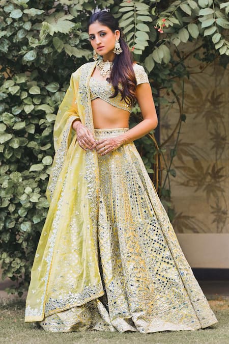 Aza - Sunshine girl #RukminiMaitra in a pastel yellow lehenga accentuated  with vibrant floral motif by #TamannaPunjabiKapoor. Find this stellar piece  by the designer at http://bit.ly/2OCS74M and at the Aza stores. #aza #