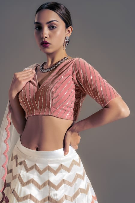Shloka Sudhakar White Net, Satin, Suede Chevron V Neck Applique Work Lehenga Set Online at Aza Fashions Shloka Sudhakar_White Net, Satin, Suede Chevron V Neck Applique Work Lehenga Set _Online_at_Aza_Fashions