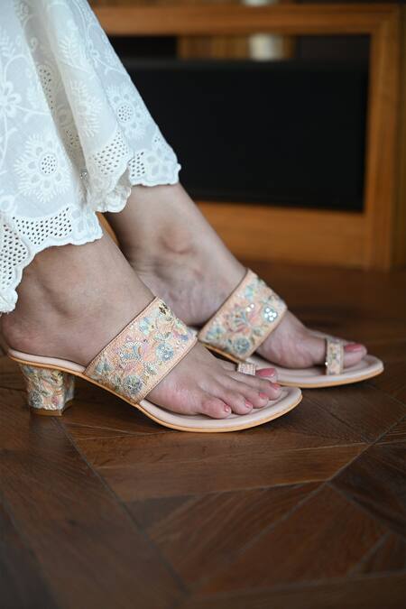 Lexica - Fashion model wearing a high-hand summer dress in peach pink colors  with flowers, high heels, a fontein en french garden in the background