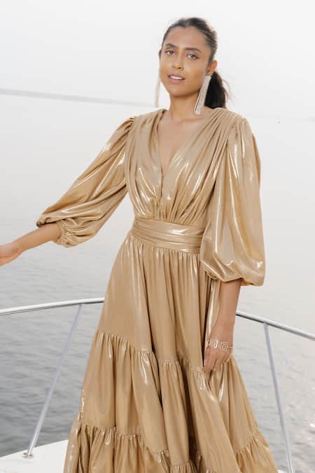 House Of Fett Gold 100% Knit Fabric Plain V Neck Tiered Gown at Aza Fashions House Of Fett_Gold 100% Knit Fabric Plain V Neck Tiered Gown_at_Aza_Fashions