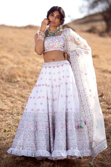 Ivory cutwork blouse, lehenga & cape – Sapana Amin