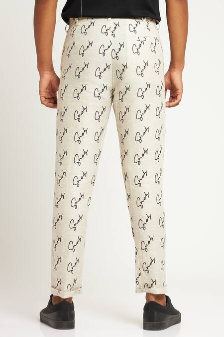 Shop Son Of A Noble Snob Ivory 100% Linen Printed Logo Toco Signature Trouser at Aza Fashions Shop_Son Of A Noble Snob_Ivory 100% Linen Printed Logo Toco Signature Trouser_at_Aza_Fashions