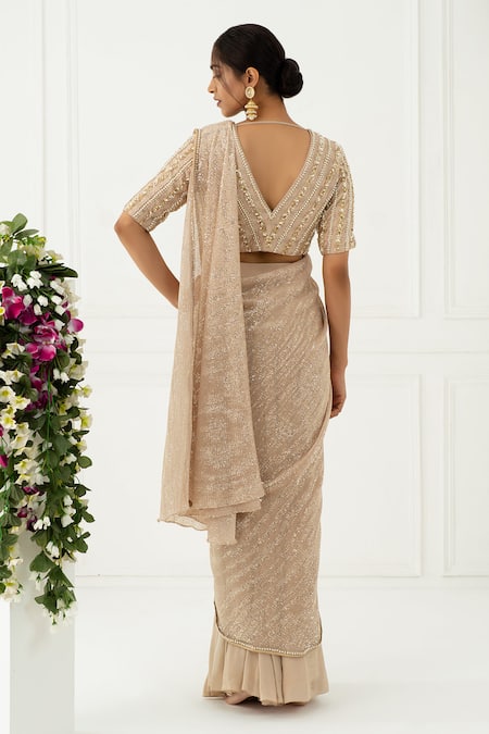 Shop NIDHIKA SHEKHAR Beige Crepe, Sequin V Neck Pre-draped Saree With Blouse at Aza Fashions Shop_NIDHIKA SHEKHAR_Beige Crepe, Sequin V Neck Pre-draped Saree With Blouse _at_Aza_Fashions