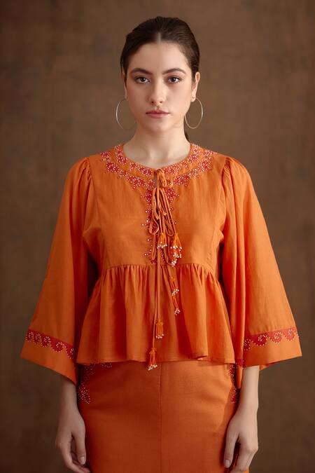 Nikasha_Orange Cotton, Silk Embroidery, Tassels Round Neck Placement Peplum Top _Online_at_Aza_Fashions