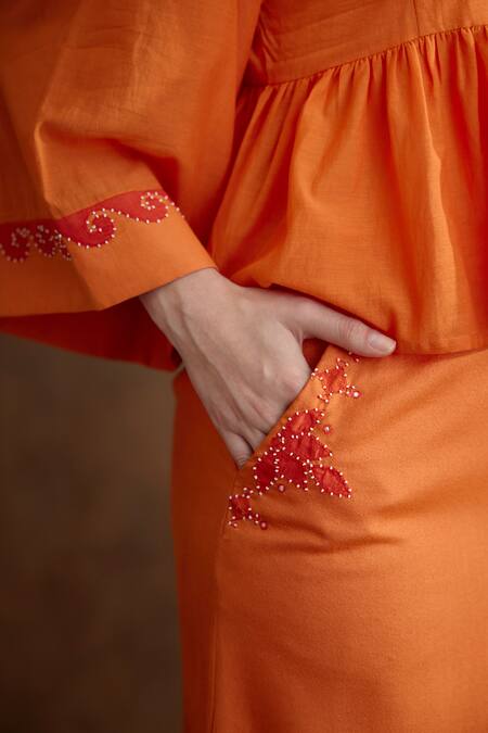 Shop_Nikasha_Orange Cotton, Silk Embroidery, Tassels Round Neck Placement Peplum Top _Online_at_Aza_Fashions