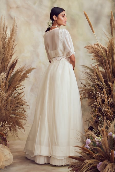 Shop Niamh By Kriti White Georgette And Organza Pearl, Bead & Cutdana Embroidered Cape Lehenga Set at Aza Fashions Shop_Niamh By Kriti_White Georgette And Organza Pearl, Bead & Cutdana Embroidered Cape Lehenga Set _at_Aza_Fashions