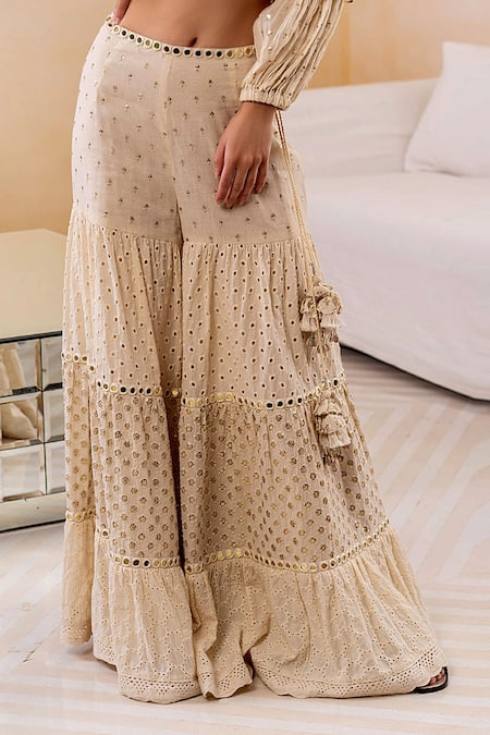 Shop Surily G Ivory Cotton Cutwork, Mirror Tiered Sharara at Aza Fashions Shop_Surily G_Ivory Cotton Cutwork, Mirror Tiered Sharara_at_Aza_Fashions