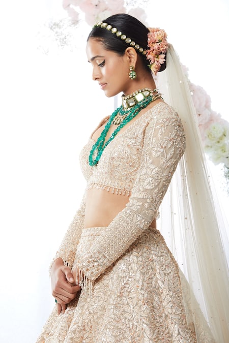 Sabyasachi - Featured here: Hand-embroidered ivory and gold bridal lehenga  with sumptuous uncut diamond and pearl jewellery from the Sabyasachi  Heritage Collection. It's paired with a hand-embroidered man's sherwani  with raw silk