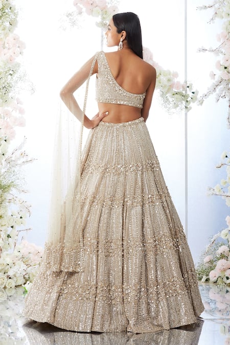 Shop Seema Gujral Beige Organza, Net Sequins One Shoulder Embellished Lehenga And Draped Blouse Set at Aza Fashions Shop_Seema Gujral_Beige Organza, Net Sequins One Shoulder Embellished Lehenga And Draped Blouse Set _at_Aza_Fashions