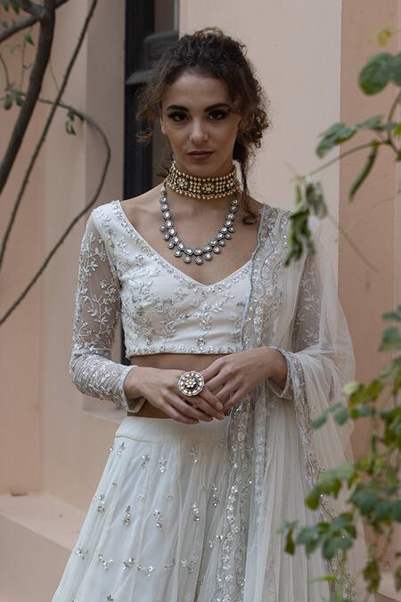 Astha Narang White Main Material Netlining Semi Crepe V Neck Embroidered Lehenga Set at Aza Fashions Astha Narang_White Main Material Netlining Semi Crepe V Neck Embroidered Lehenga Set _at_Aza_Fashions