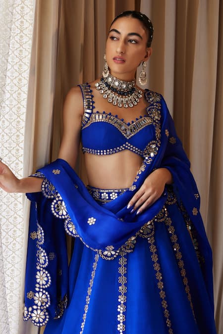 PEACOCK BLUE LEHENGA SET WITH PATTERNED SILVER EMBROIDERY PAIRED WITH A  MATCHING DUPATTA AND ALL OVER SILVER EMBELLISHMENTS. - Seasons India