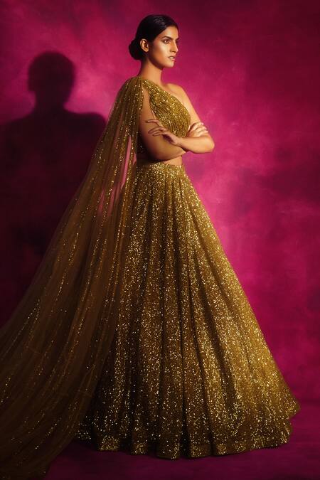 Shop_Vvani By Vani Vats_Gold Net Asymmetric Sequin Embroidered One Shoulder Lehenga Set _at_Aza_Fashions