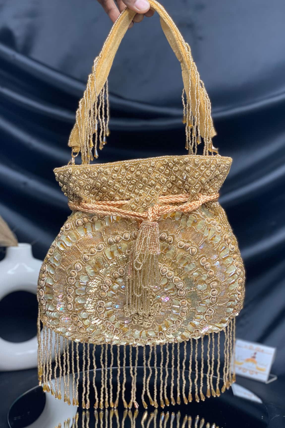 Kainiche by Mehak Gold Embellished Potli with Beaded Fringes 