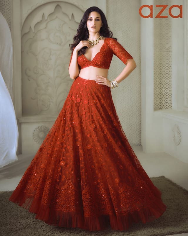 Amyra_Dastur_in_Red_lehenga_highlighted_with_intricate_tone_on_tone_jaal_embroidery_and_drawstring_at_the_waist_Comes_with_plunging_neckline_blouse_and_belt_dupatta