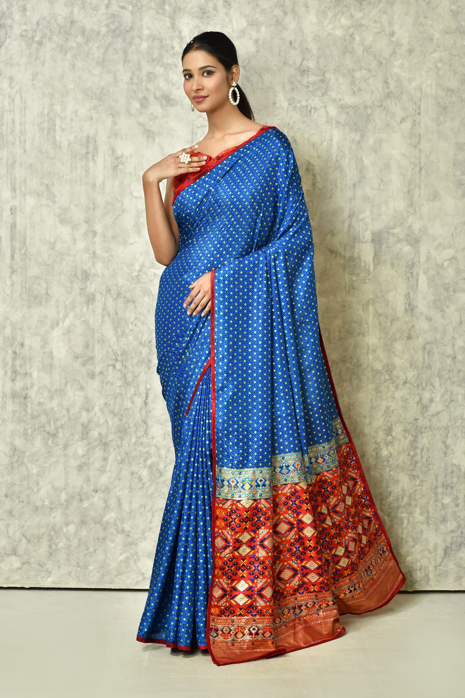 In a gorgeous red color saree, dark blue color sleeveless blouse design and  necklace | Saree hairstyles, Designer saree blouse patterns, Saree