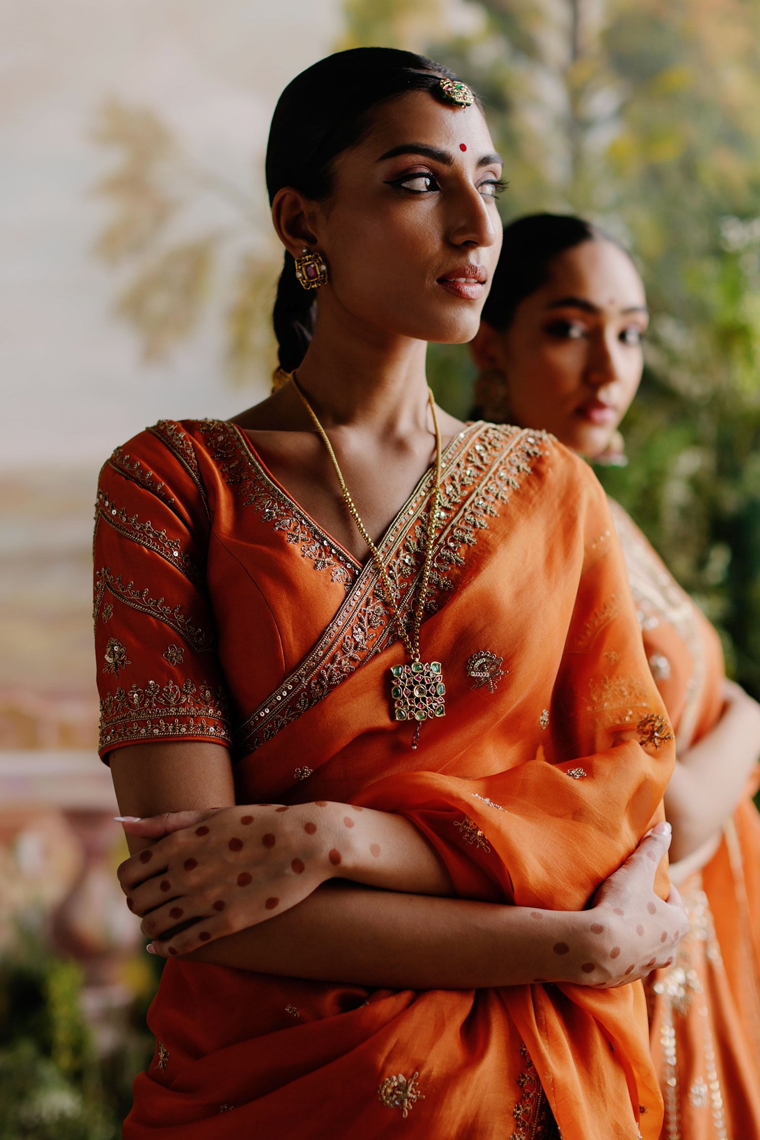 Photo of South Indian bridal jewellery with orange and green saree