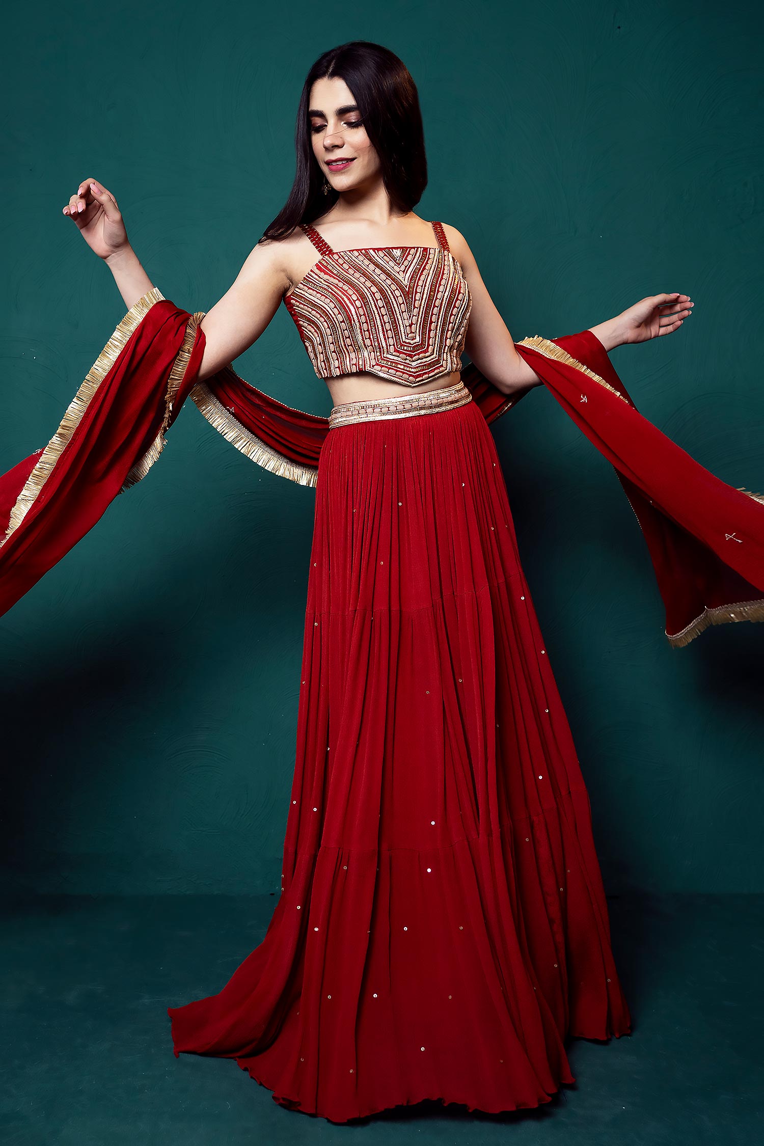 MAROON RED BUTI WORK LEHENGA SET WITH A HAND EMBROIDERED MIRROR WORK BLOUSE  PAIRED WITH A MATCHING DUPATTA AND GOLD EMBELLISHMENTS. - Seasons India