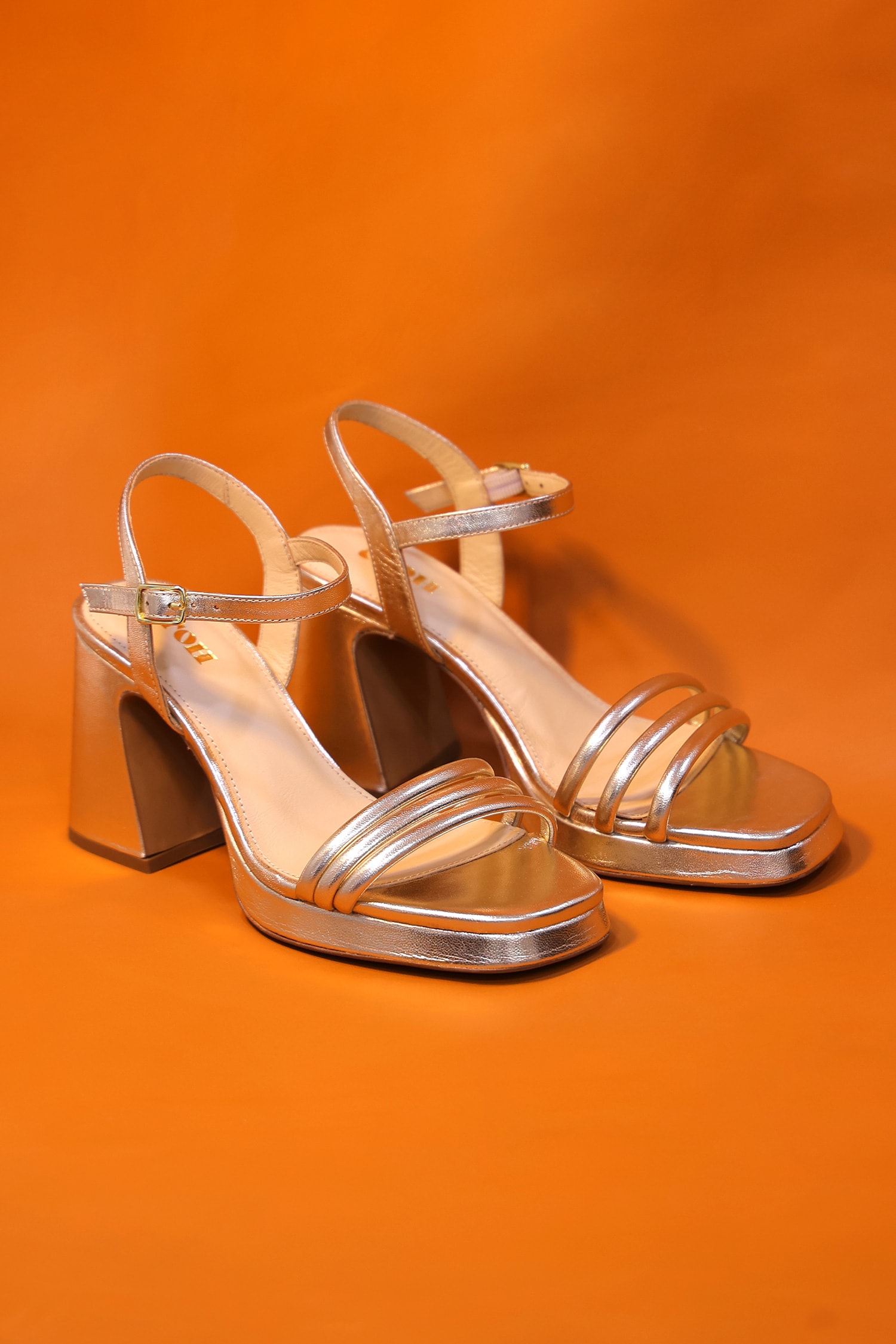 Buy Gold Plain Metallic Platform Heels by OROH Online at Aza Fashions.