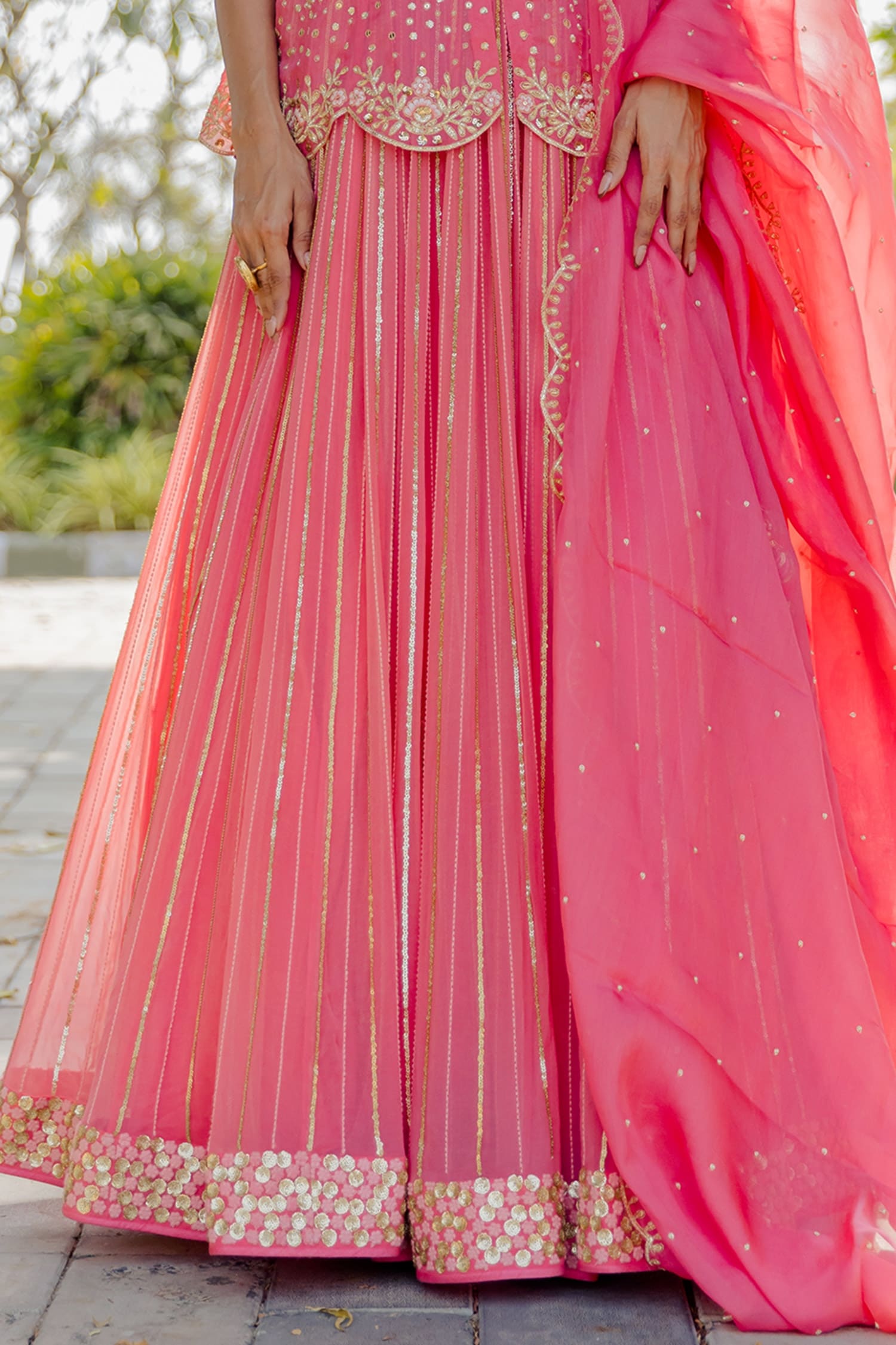 Pop pink embroidered raw silk peplum top with orange net kalamkari  embroidered lehenga