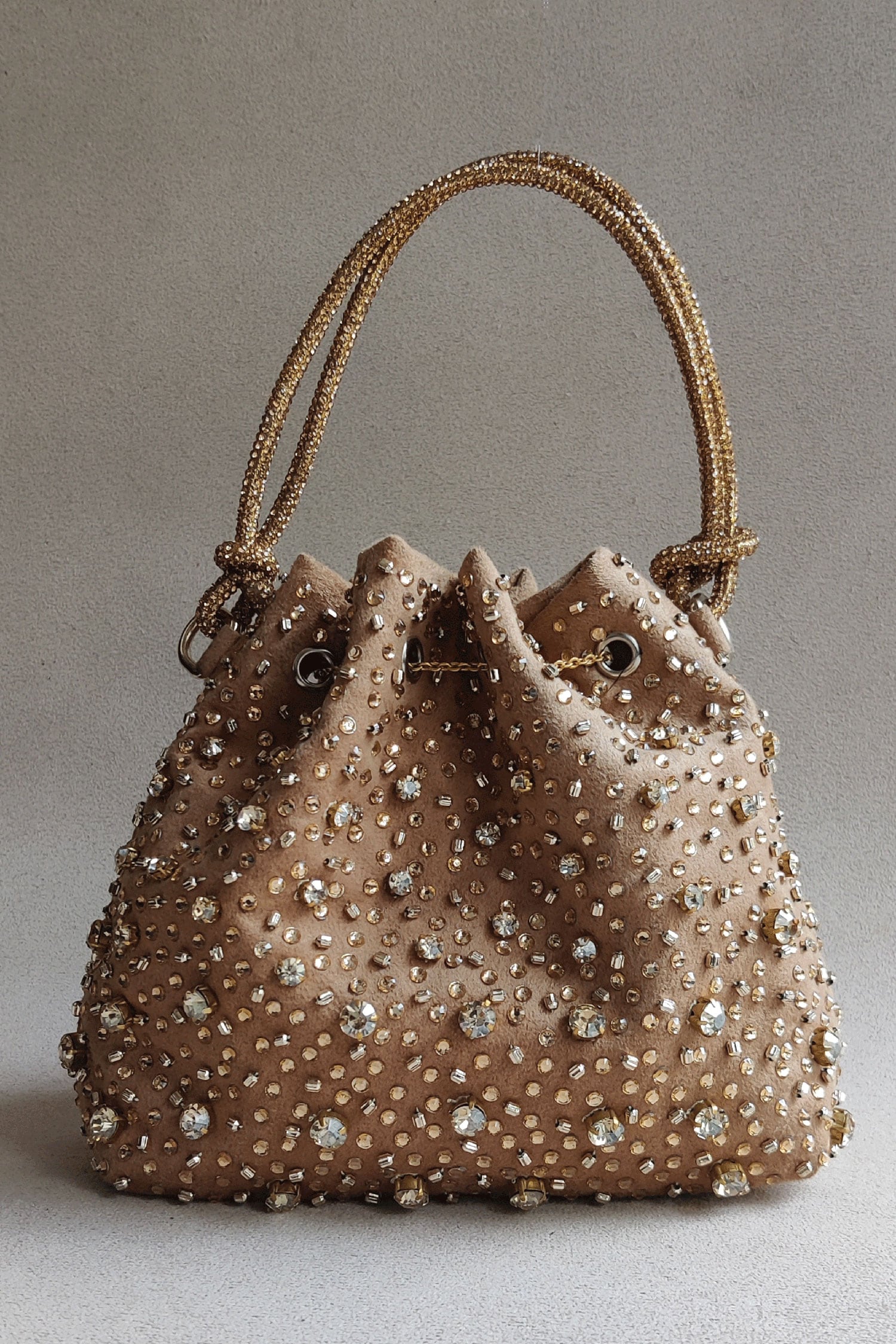 Buy Gold Embellished Rhinestone Bucket Bag by Plode Online at Aza Fashions.