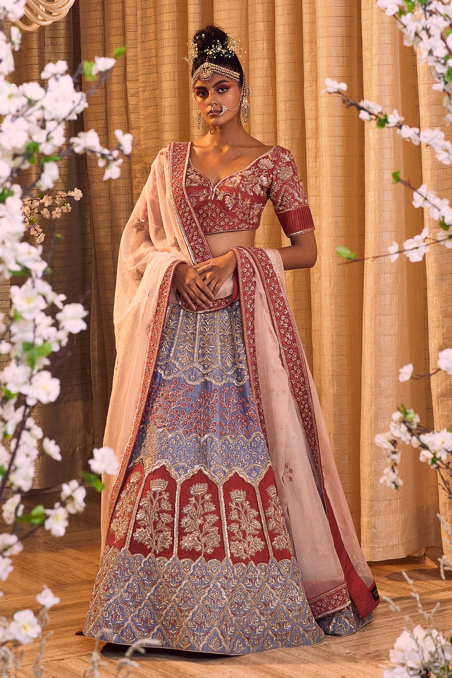 Photo of Maroon bridal lehenga and peach sherwanu sabyasachi